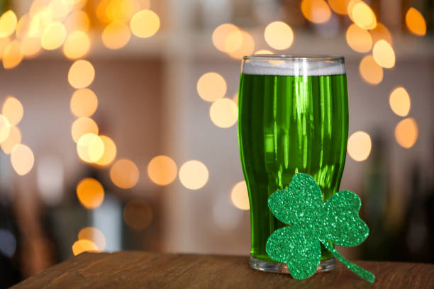 Green beer and clover on wooden counter, space for text. St.Patrick's Day celebration Green beer and clover on wooden counter, space for text. St.Patrick's Day celebration st. patricks day photos stock pictures, royalty-free photos & images