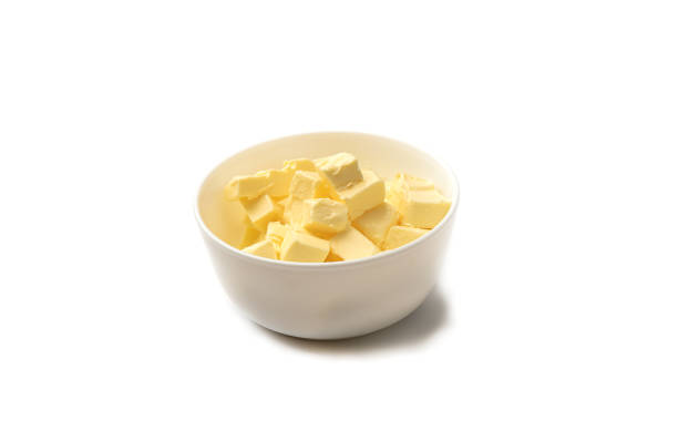 istock Diced butter in a white cup over a white background. 1333213007