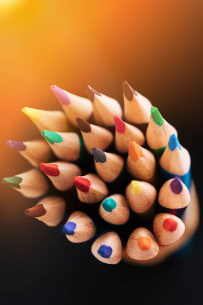 istock New color sharpened pencils on a dark background with sunlight or illumination. Abstract background on a creative theme 1333213266