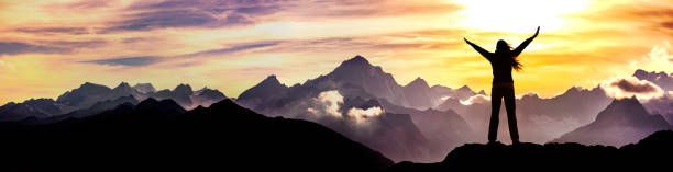 istock Woman with arms outstretched on a mountain top 1333214040