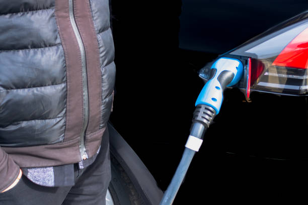 istock Man waiting near the electric car 1333214368