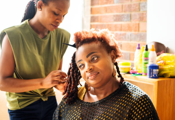Hairstylist braiding a client's hair during a hair appointment