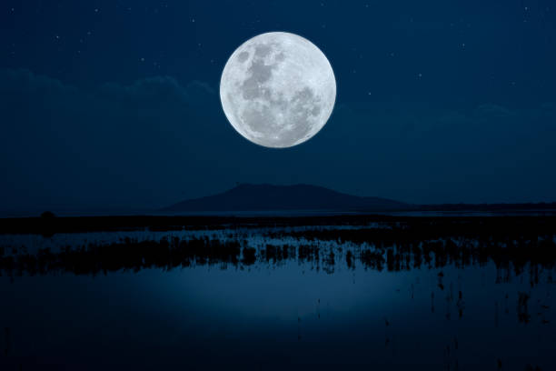 istock Full moon on sky over lake in the night. 1333217999