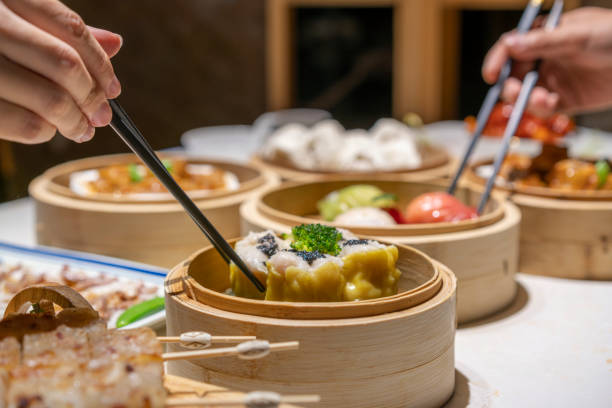 istock People eating Guangdong dum sum with chopsticks 1333220676
