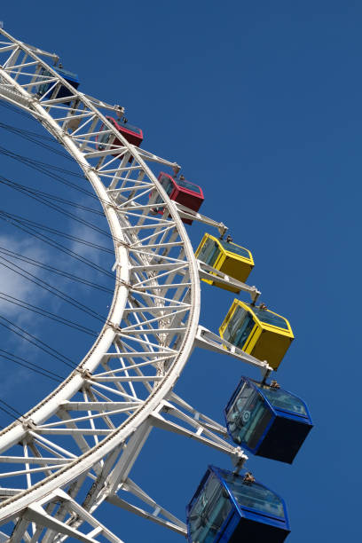 istock low angle view of ferris wheel cabins and blue sky 1333220784