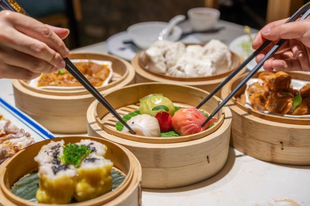 istock People eating Guangdong dum sum with chopsticks 1333220839