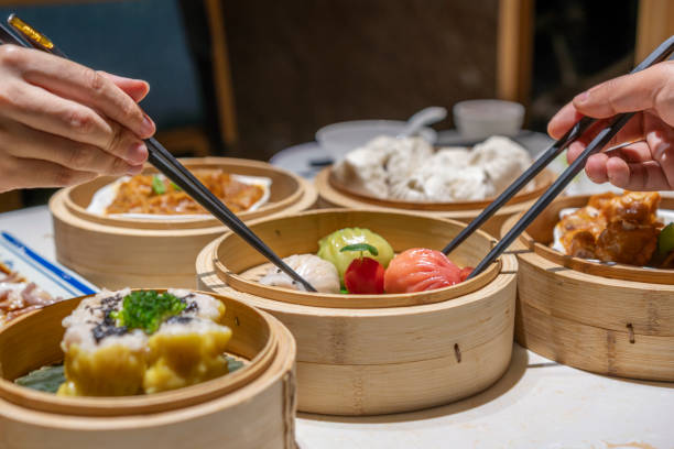 istock People eating Guangdong dum sum with chopsticks 1333222039