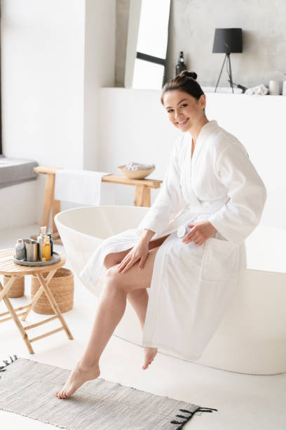 Smooth skin after shaving. Woman applying moisturizer cream on legs after shaving. Spa beauty treatment at home. Skin body care Smooth skin after shaving. Woman applying moisturizer cream on legs after shaving. Spa beauty treatment at home. Skin body care home pedicure stock pictures, royalty-free photos & images