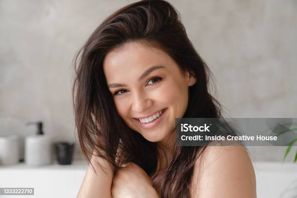 Young Beautiful Caucasian Woman With Shiny Long Brown Straight Hair Touching It For Good Volume Hair And Skin Care Beauty Treatment Concept Stock Photo - Download Image Now