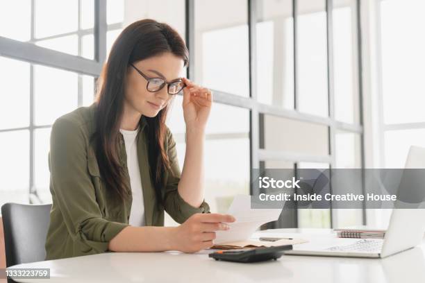 Successful Young Business Woman Freelancer Manager Accountant Counting Funds Savings Money Using Calculator In Office Woman Paying Domestic Bills Economizing Economy And Finances Concept Stock Photo - Download Image Now