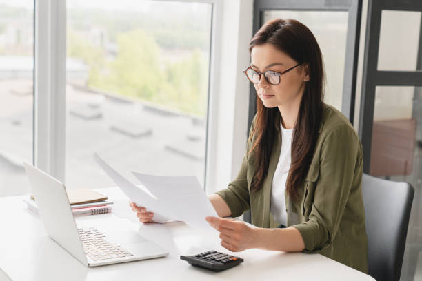 istock Caucasian concentrated business woman manager freelancer boss doing paperwork, checking documents, e-learning, signing conctracts in office. Finance and economy concept 1333223771