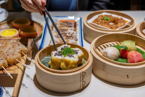 istock People eating Guangdong dum sum Siu Mai with chopsticks 1333224249