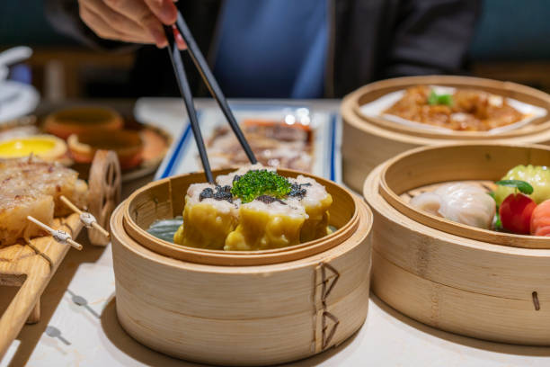 istock People eating Guangdong dum sum Siu Mai with chopsticks 1333224281