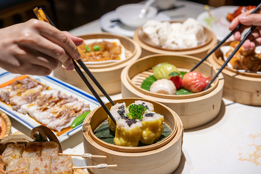 Dum sum including Three-colored Shrimp Dumplings, Honeycomb Tripes, Fried Turnip Cake, Siu Mai, Egg Tart, Barbecued Pork Bun, Pork Ribs in Black Bean Sauce, Sweet and Sour Pork, Steamed Vermicelli Roll or Chee Cheong Fun in the restaurant in Guangzhou, Guangdong, China.