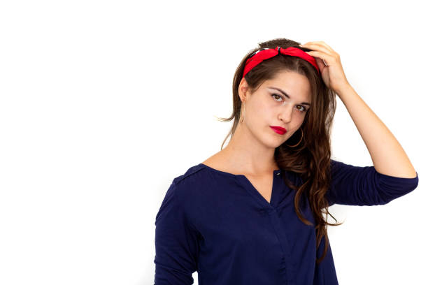 Young women in blue clothes looking at camera on white background
