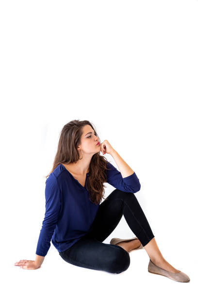 istock Young women sitting on the white background 1333227975