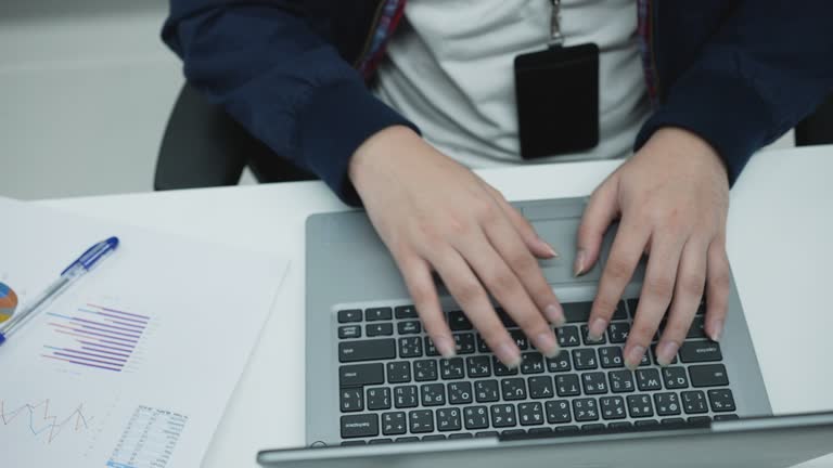 slow motion top view scene of accountant man using calculating on calculator to summarize or consider on statistic report at office for business and financial concept