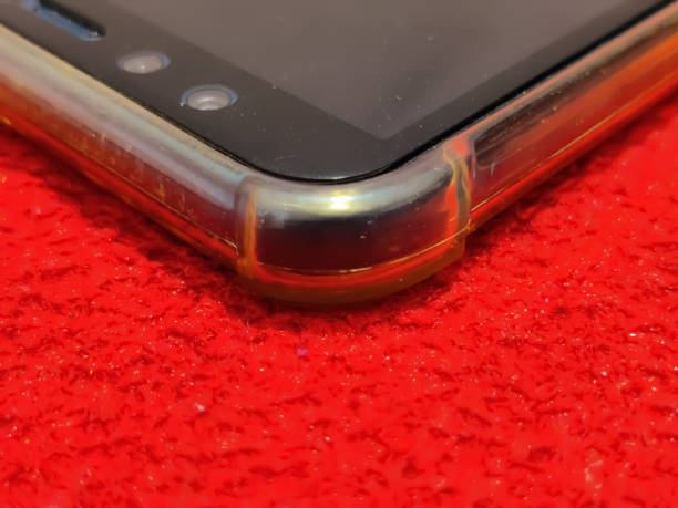 istock Beautiful Closeup view from a corner of a mobile phone isolated on a red surface 1333234334