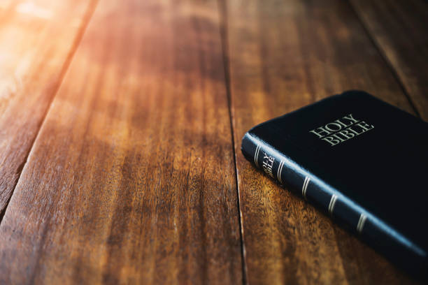 holy bible on the wooden table background with soft morning sunlight Christian background with copy space holy bible on the wooden table background with soft morning sunlight Christian background with copy space bible stock pictures, royalty-free photos & images