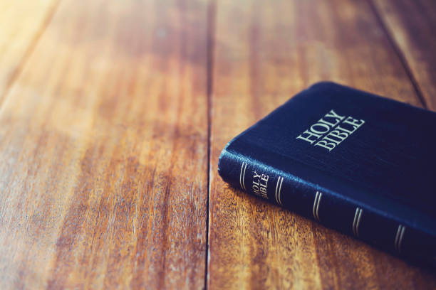 istock holy bible on wooden table background with soft morning sun light 1333234466