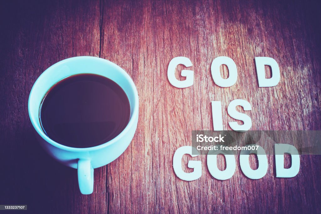 Word 'God is good' with a cup of coffee on wooden table, christian concept background God Stock Photo