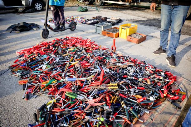 man standing besides a lot of new hand work tools, street sale of screwdrivers, pliers, wrenches. Set of mechanical tools for manual work at flea market Nis, Serbia, 27. February, 2021: man standing besides a lot of new hand work tools, street sale of screwdrivers, pliers, wrenches. Set of mechanical tools for manual work at flea market purchase of steel scrap stock pictures, royalty-free photos & images