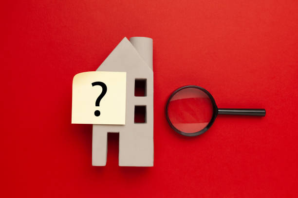istock Real estate and question mark on a red background. Home inspection and hidden defects 1333237471