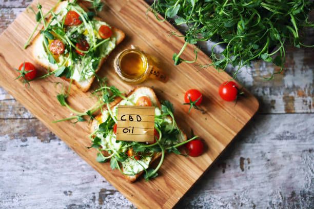 Toast with microgreens and cannabis oil. Cbd oil note. stock photo