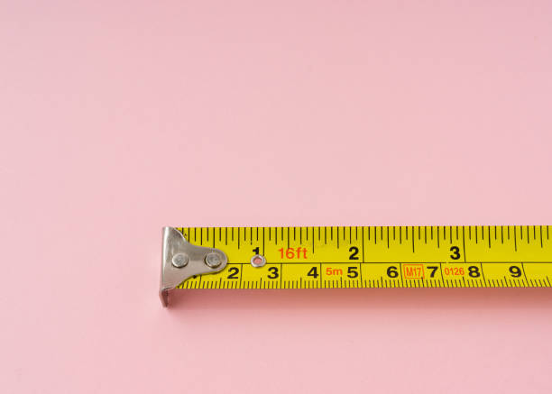 Measuring Tape With Centimeters And Inches On Pink Background Stock Photo -  Download Image Now - iStock
