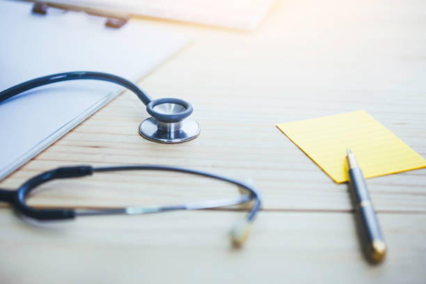 istock Stethoscope over paper clipboard  with pen on small note paper  on doctor table or office, medical class or knowledge. 1333240356