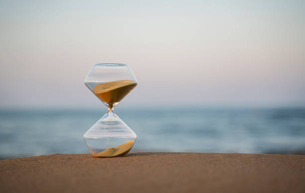 istock Flowing hourglass on the beach at sunrise 1333243347