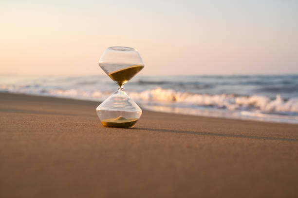 istock Flowing hourglass on the beach at sunrise 1333243349