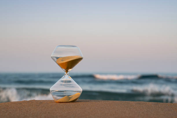 istock Flowing hourglass on the beach at sunrise 1333243469
