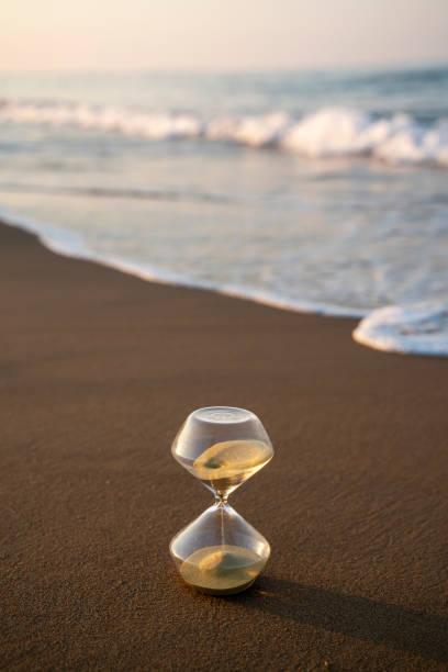 istock Flowing hourglass on the beach at sunrise 1333243694