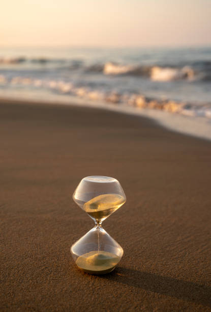 istock Flowing hourglass on the beach at sunrise 1333243702
