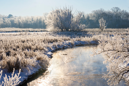 The Bark River in Waukesha County Wisconsin on a clear cold winter's morning.  Hoar frost covers the river bottom.