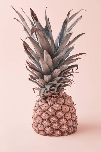 istock Tropical pineapple fruit on a pink background with a copy space. 1333248407