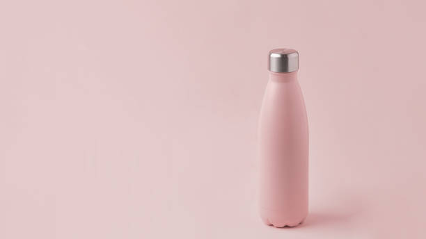 istock Pink thermos and half a coconut. 1333248666