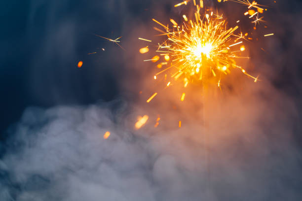 istock fire sparkler in dense smoke, abstract Christmas firework background 1333250582