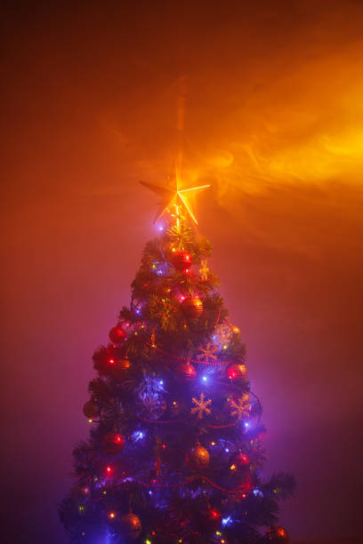 istock Christmas tree with shining star and dense smoke 1333250600