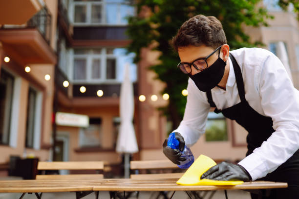 istock Disinfecting cafe tables to prevent COVID-19. 1333253743