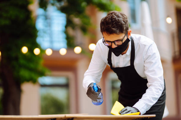 istock Disinfecting cafe tables to prevent COVID-19. 1333253830