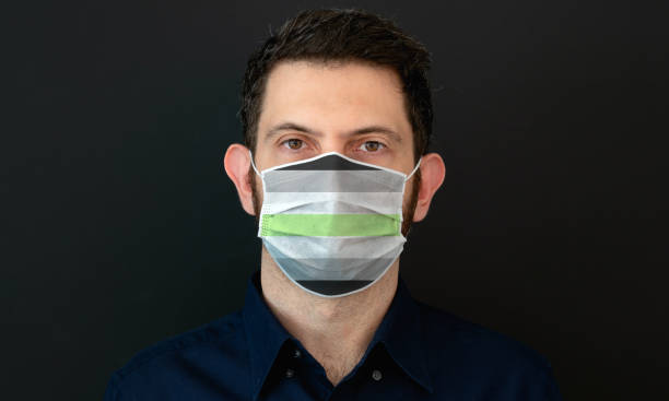 istock Man wearing a LGBT agender flag colors protective face mask. 1333254745