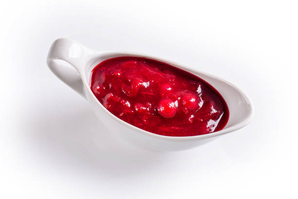 istock Cranberry sauce in white gravy boat on white background. 1333254748