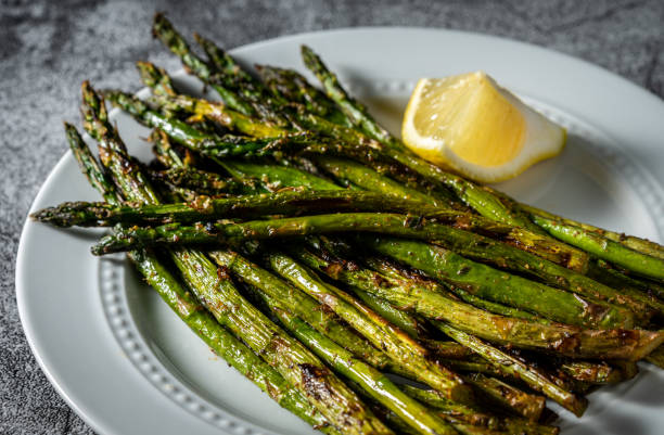 Grilled Asparagus spears on serving dish. Close up, above photography. Asparagus stock pictures, royalty-free photos & images