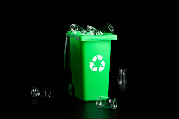 istock Trash glass sort. Bin container for disposal garbage waste and save environment. Green dustbin for recycle glass can trash isolated on black background. 1333256565