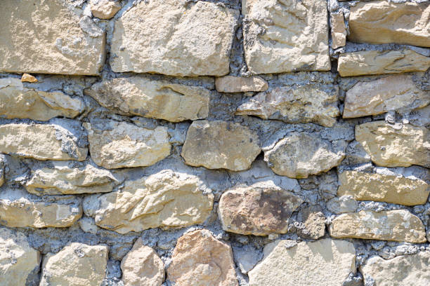 istock The rough textured surface of the wild stone wall. Background. 1333257897