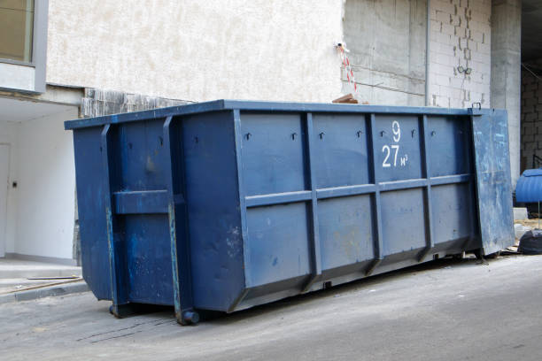 istock Metal durable blue industrial trash bin for outdoor trash at construction site. Large waste basket for household or industrial waste. A pile of waste 1333258194