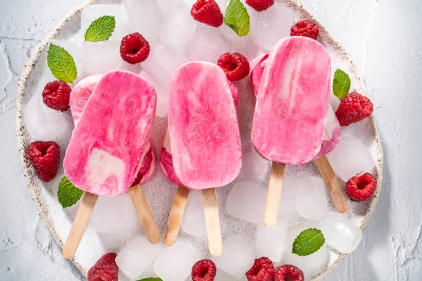 istock Raspberry berries homemade popsicles with mint leaves on ice cubes in white plate 1333258199