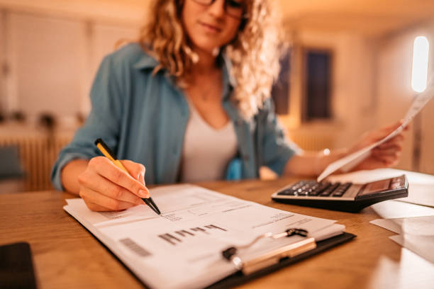 istock Woman Sitting in her Home Office and doing Paperwork 1333259244